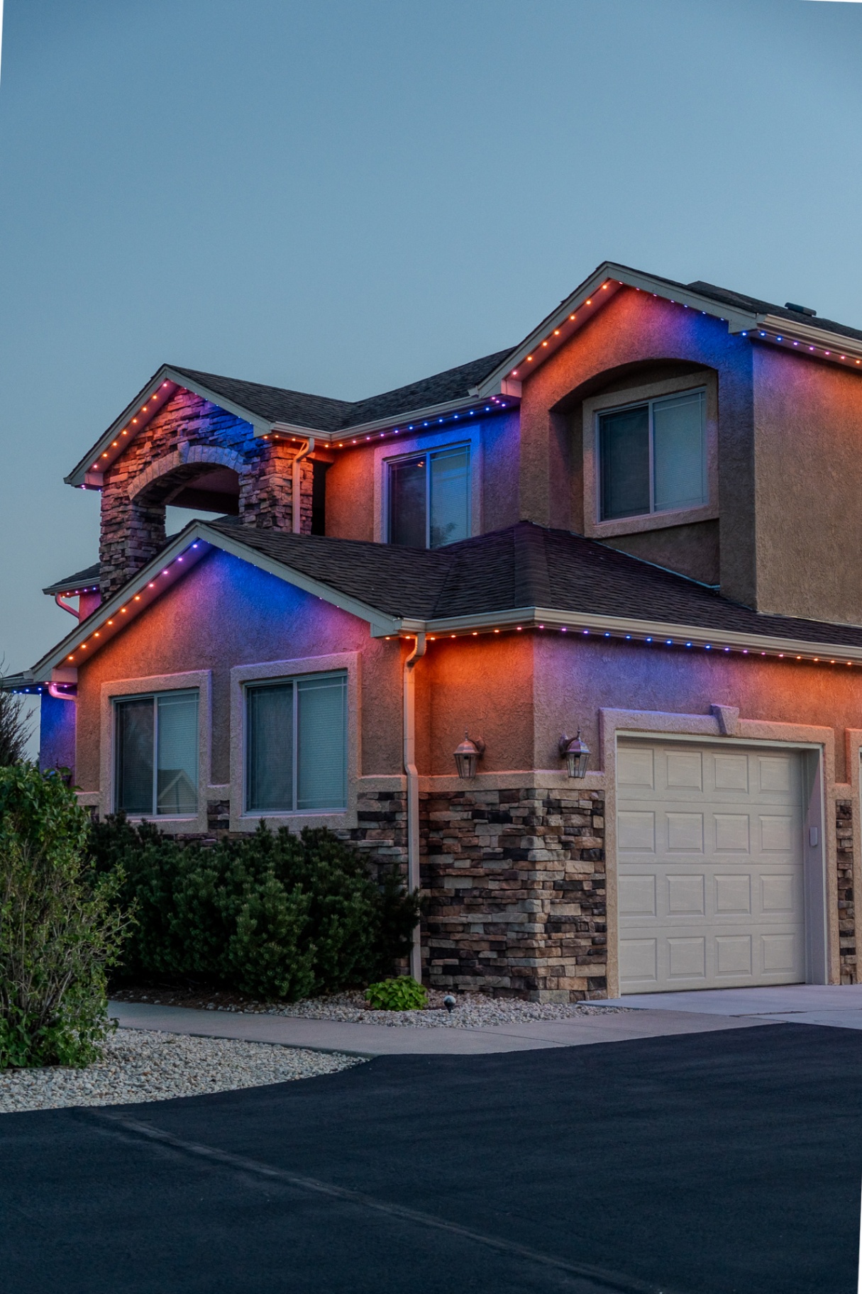Orange and blue lighting across a large home exterior