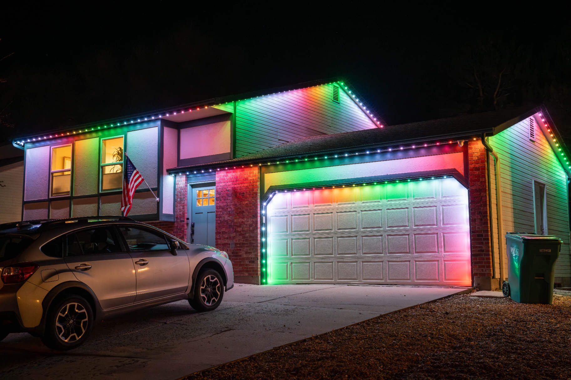 Vivid multicolor lighting on a home with American flag