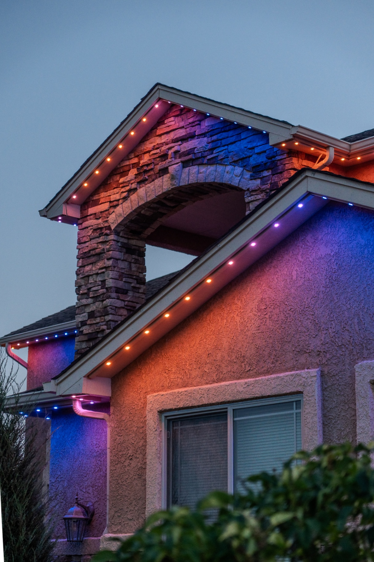 Orange, purple, and blue lighting close-up on a stone home