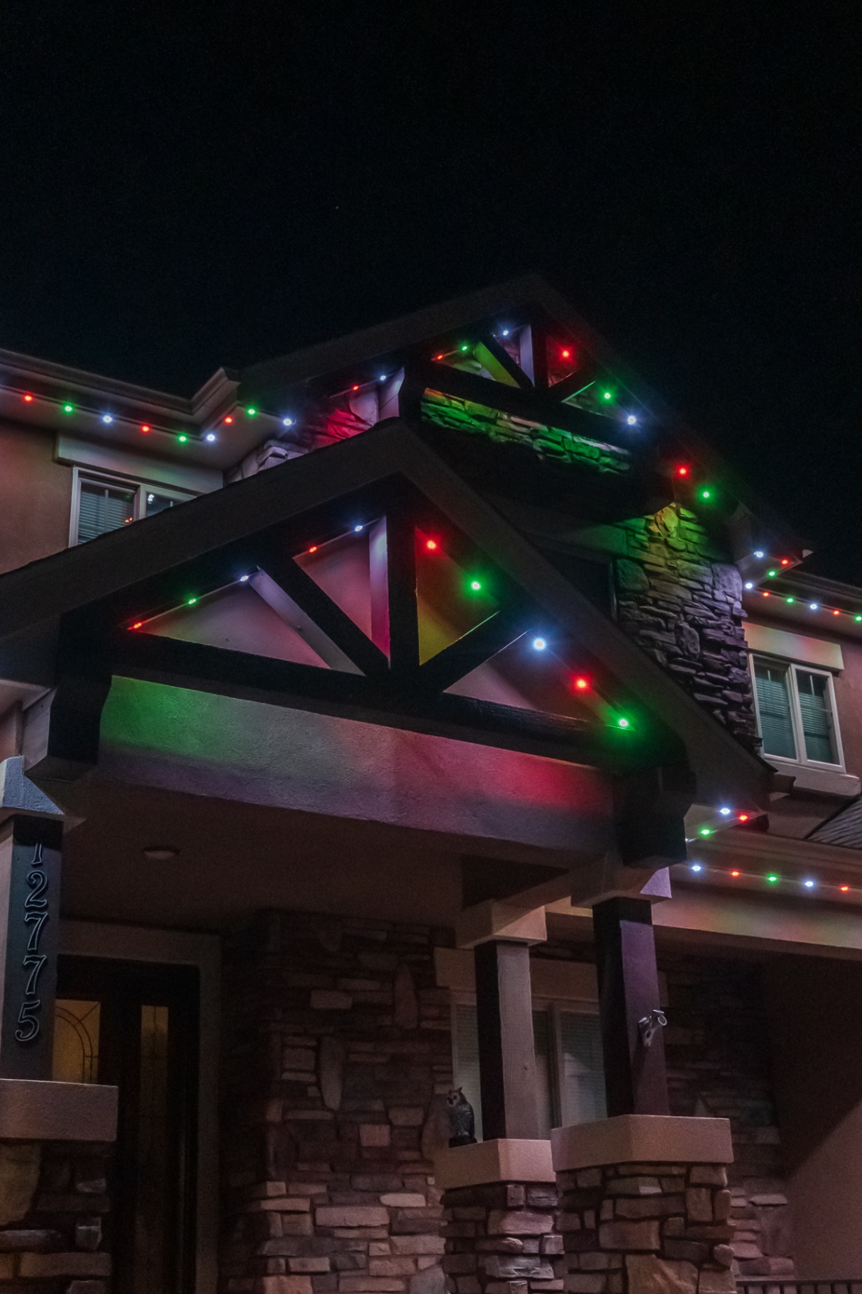 Red, green, and white classic Christmas lighting on timber accents